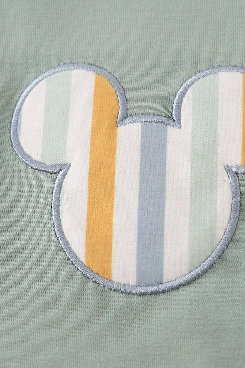 Green character applique bubble
