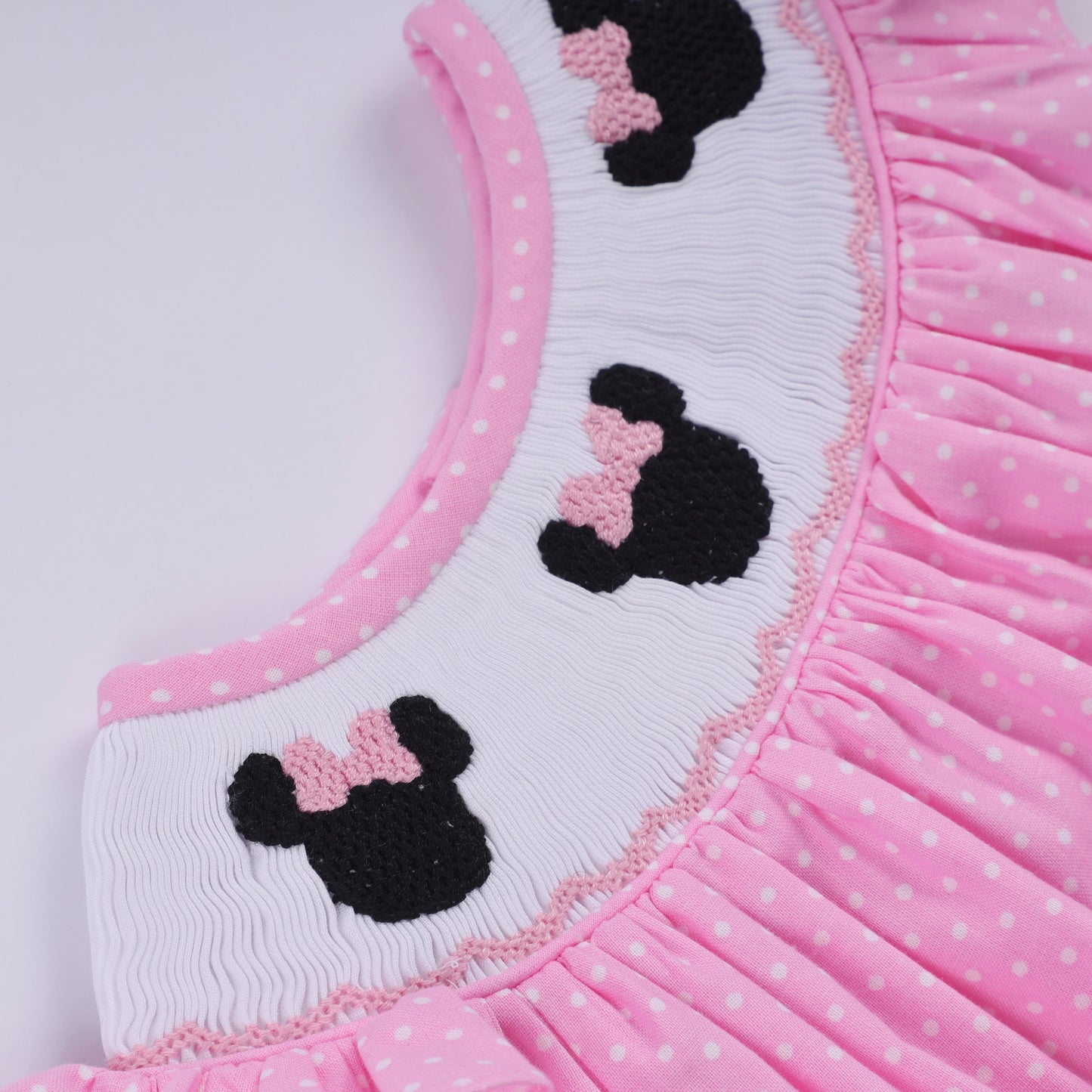 Pink character hand smocked dot ruffle bubble